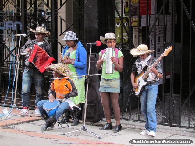 A family of buskers perform in a Bogota street. (640x480px). Colombia, South America.