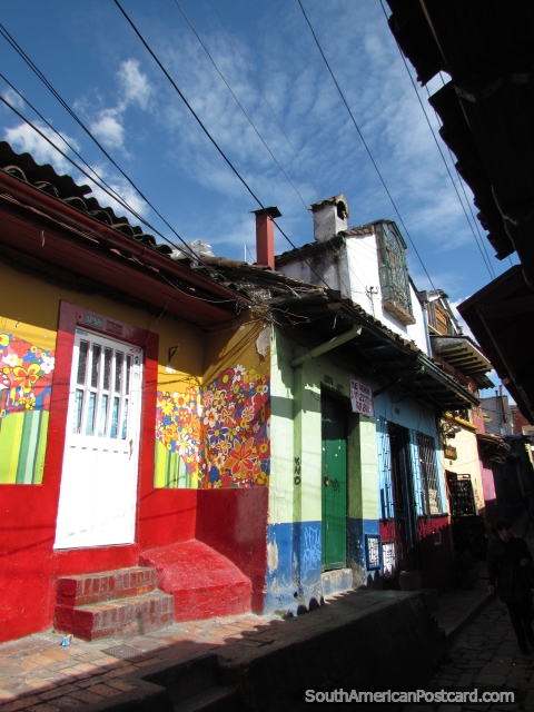 Red shop with painted flowers in alleyway in La Candelaria, Bogota. (480x640px). Colombia, South America.