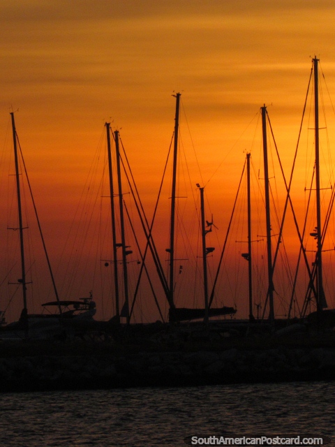 Masts of sailboats at the yacht club in Santa Marta and an orange sunset. (480x640px). Colombia, South America.