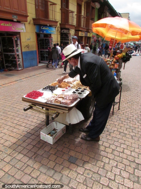 Man sells fresh nuts and fruit nibbles in Bogota center. (480x640px). Colombia, South America.