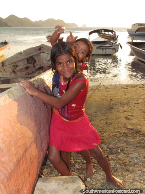 2 local girls of Taganga love to play on the boats. (480x640px). Colombia, South America.