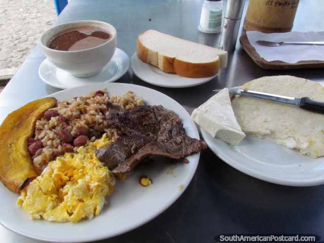 Meat, rice with red beans, scrambled eggs and cooked banana plus an arepa, white cheese, bread and hot chocolate - my lunch in Guatape. (640x480px). Colombia, South America.