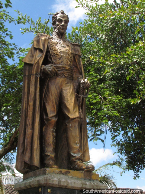 Gold Simon Bolivar statue in the corner of Guatape plaza. (480x640px). Colombia, South America.