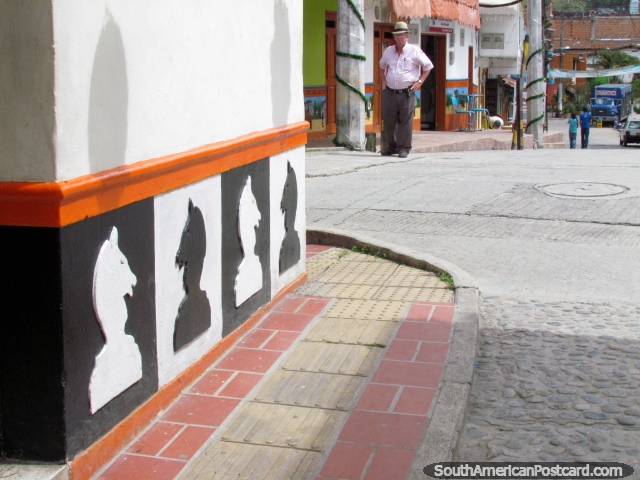 Chess pieces skirting on a cobblestone street corner in Guatape. (640x480px). Colombia, South America.