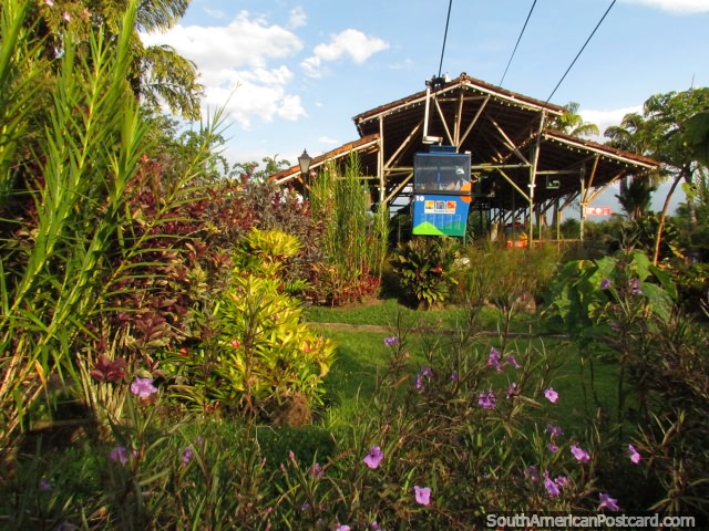 Blue cable car takes off from the station at the Coffee Park in Armneia. (640x480px). Colombia, South America.