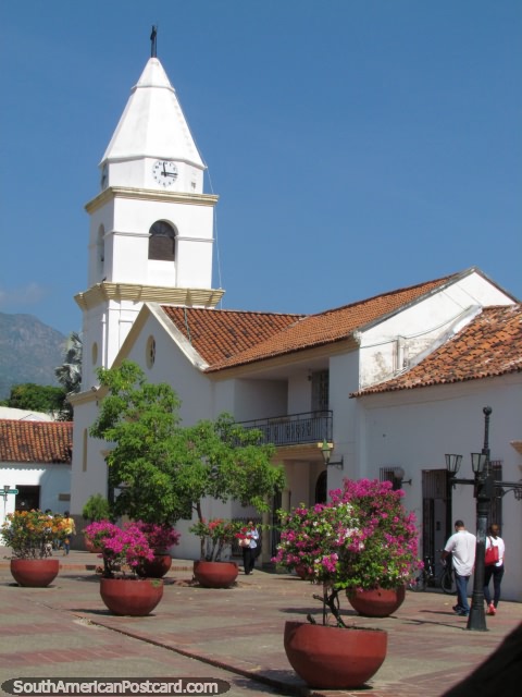 Large flower pots and the church at Plaza Alfonso Lopez in Valledupar. (480x640px). Colombia, South America.