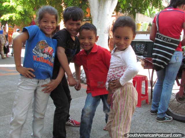 4 cute kids of Valledupar pose for a photo in the street. (640x480px). Colombia, South America.