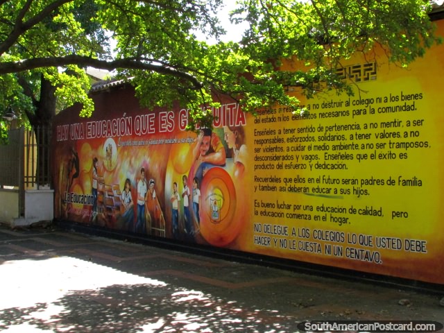 A colorful mural promoting education underneath a sunny green tree in Valledupar. (640x480px). Colombia, South America.
