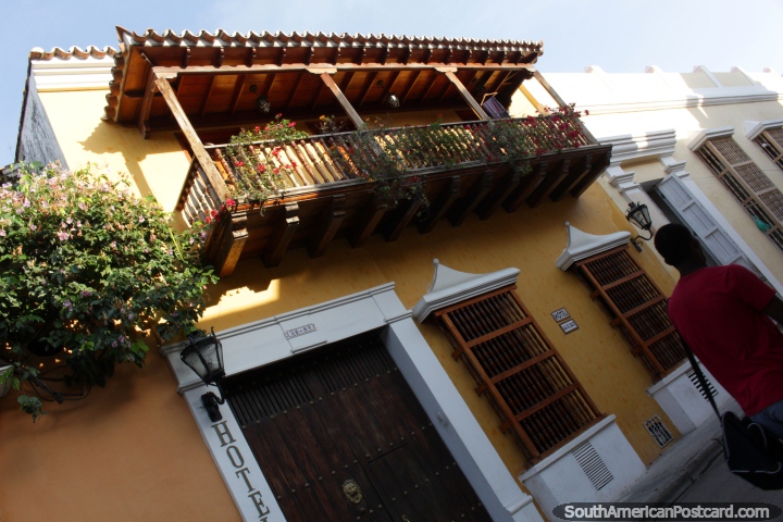 Wooden balconies with colored flowers, tiled roofs, this is Cartagena. (720x480px). Colombia, South America.