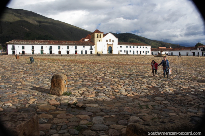 The huge iconic cobblestone Plaza Mayor and white church in Villa de Leyva. (720x480px). Colombia, South America.