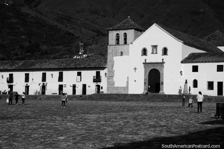 La plaza icnica hecha de adoquines y iglesia en Villa de Leyva, foto en blanco y negro. (720x480px). Colombia, Sudamerica.