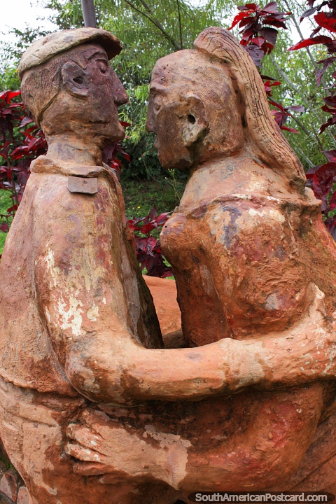 Man and woman dancing in the garden, ceramic art at the Terracotta House in Villa de Leyva. (480x720px). Colombia, South America.