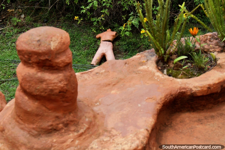 Ceramic mannequin lying on the lawn, view from a  patio at the Terracotta House in Villa de Leyva. (720x480px). Colombia, South America.