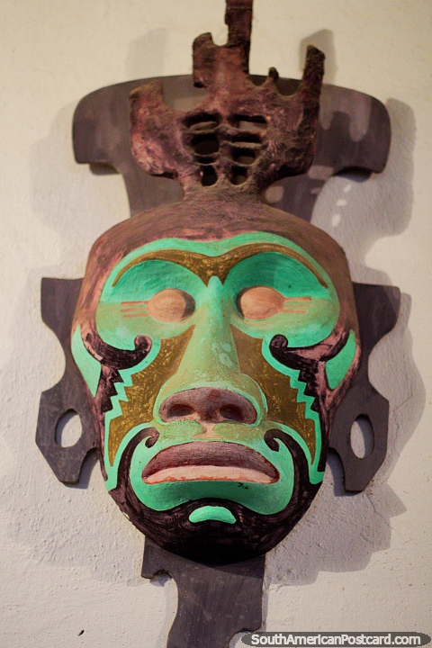 Green mask depicting an ape, the work of artist Luis Alberto Acuna in Villa de Leyva. (480x720px). Colombia, South America.