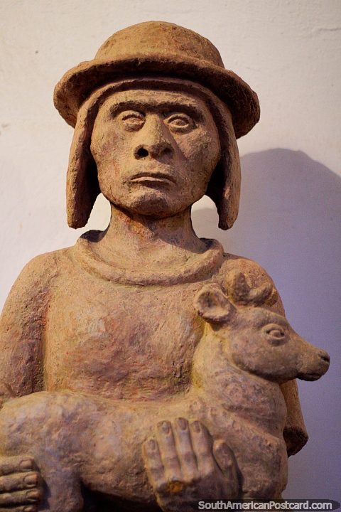 Figure holding a baby animal on display at the museum of Luis Alberto Acuna in Villa de Leyva. (480x720px). Colombia, South America.