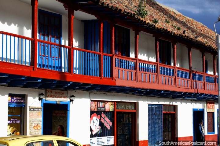 As lojas abaixo de balcões de madeira tipificam a praça pública principal em Zipaquira. (720x480px). Colômbia, América do Sul.