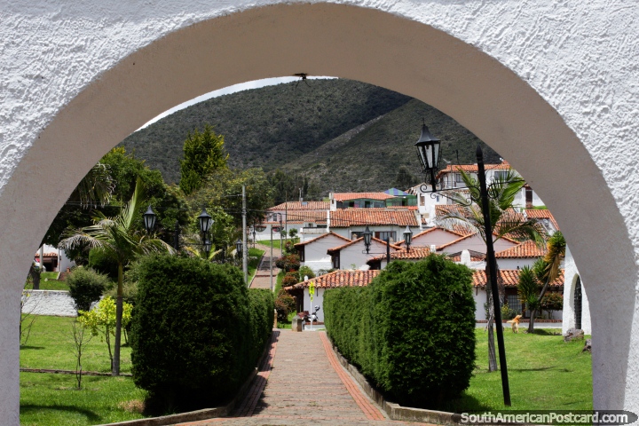 Archway and pathway with hedges leading up towards houses in Guatavita. (720x480px). Colombia, South America.
