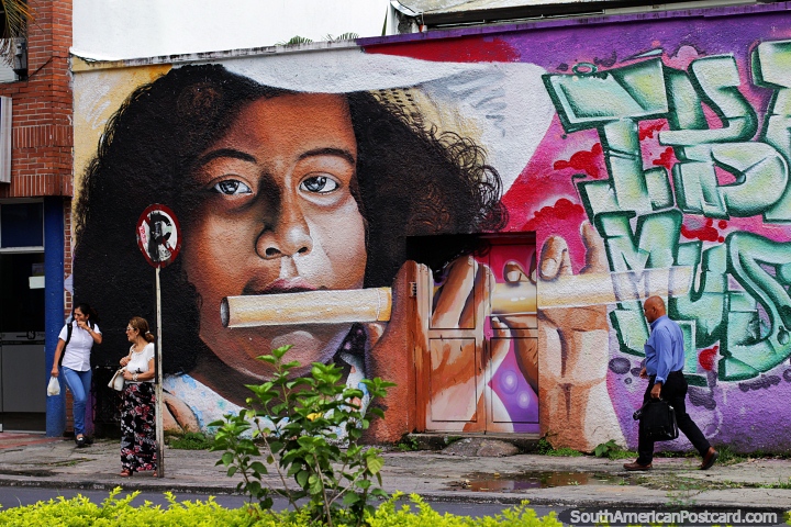 Girl plays flute, street art with musical themes all around Ibague, the music capital. (720x480px). Colombia, South America.