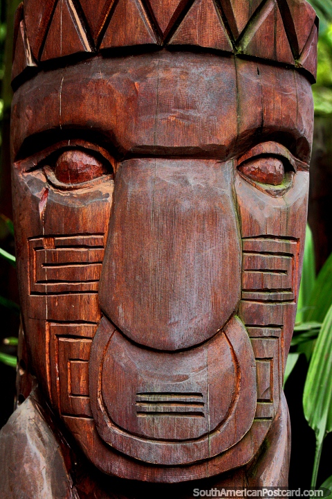 Carved wooden sculpture of an indigenous warrior on display at Cali Zoo. (480x720px). Colombia, South America.