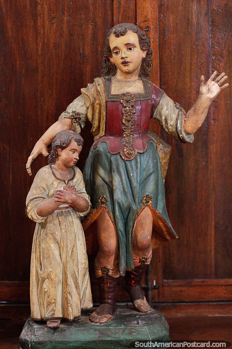 Antique religious figures stand side by side at La Merced Museum of Religious Art in Cali. (480x720px). Colombia, South America.
