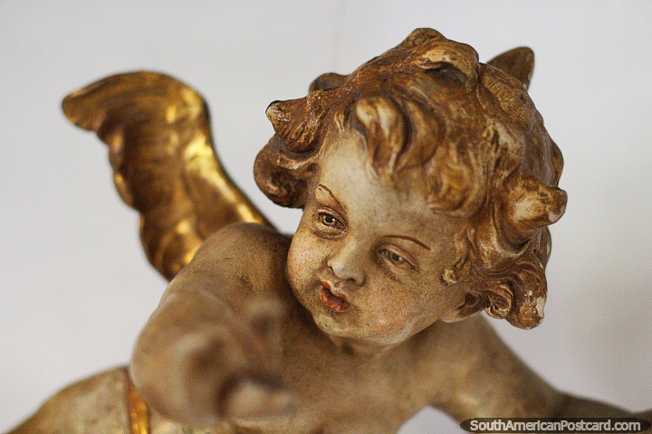 Angel Nino Volando, a gold angel at La Merced Museum of Religious Art in Cali.  (720x480px). Colombia, South America.
