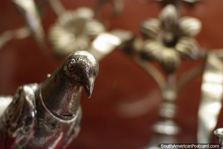 Silver bird and distant flowers, antiques at La Merced Museum of Religious Art in Cali. (720x480px). Colombia, South America.