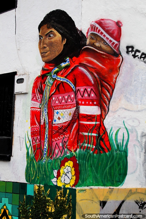 Indigenous woman with traditional clothes carries her baby on her back, street art in Cali. (480x720px). Colombia, South America.