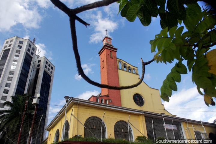 Yellow cathedral in Buenaventura with red clock and bell tower, established in 1952. (720x480px). Colombia, South America.