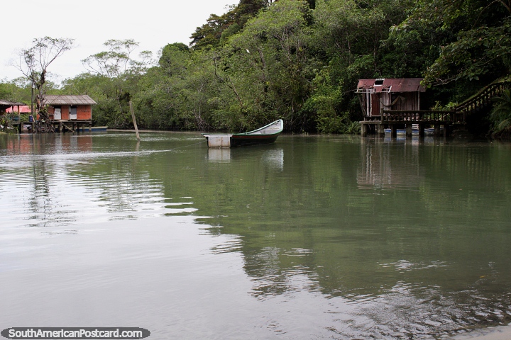 An inlet with houses above the water at the southern end of Juanchaco beach, Buenaventura. (720x480px). Colombia, South America.
