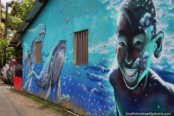 Mural of a young boy swimming with whales in Juanchaco - a beach north of Buenaventura. (720x480px). Colombia, South America.
