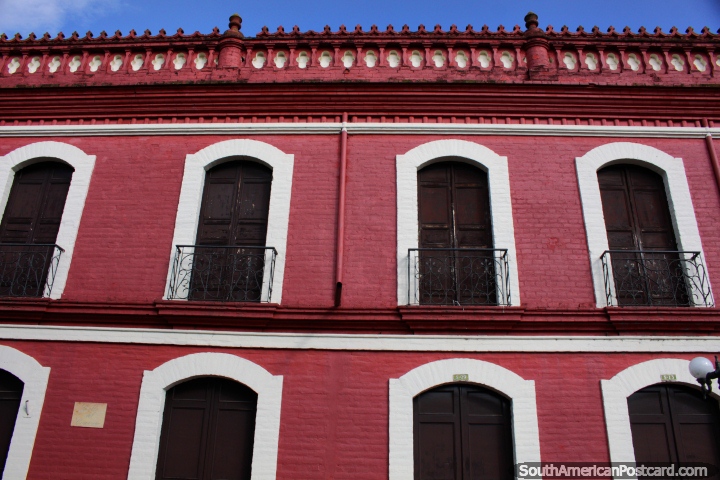 Historical Cloister of the Academic College in Buga, large red building with wooden doors and iron balconies. (720x480px). Colombia, South America.