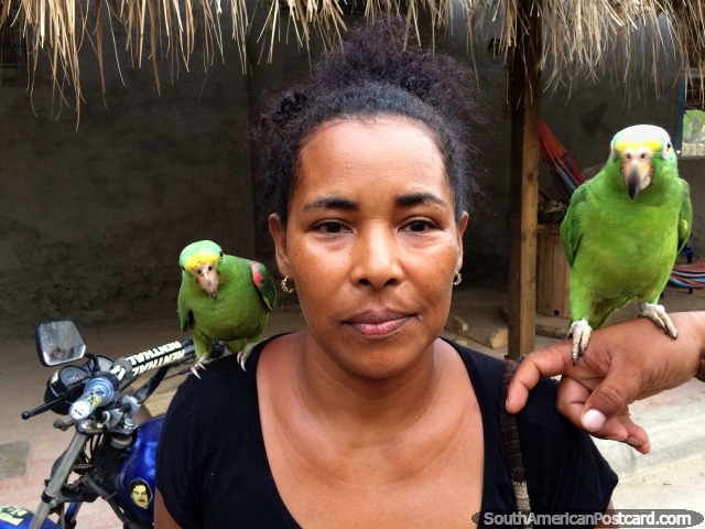 Woman with 2 pet parakeets in Taganga, all members happy for a photo. (640x480px). Colombia, South America.