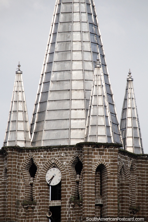 Clock tower with small and large silver steeples, the church in Jardin. (480x720px). Colombia, South America.
