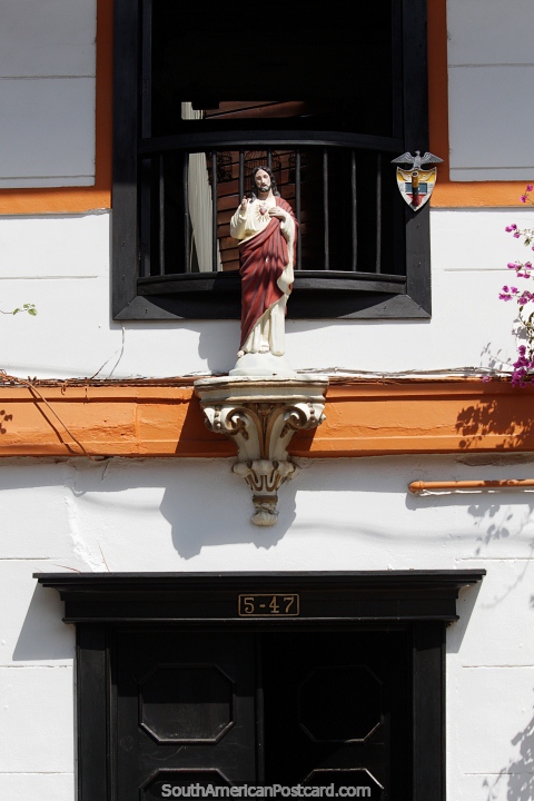 Religious icon, part of the facade above a shop entrance in Jardin. (480x720px). Colombia, South America.