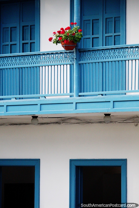 Flowers compliment the nice buildings of Jardin with beautiful colors. (480x720px). Colombia, South America.