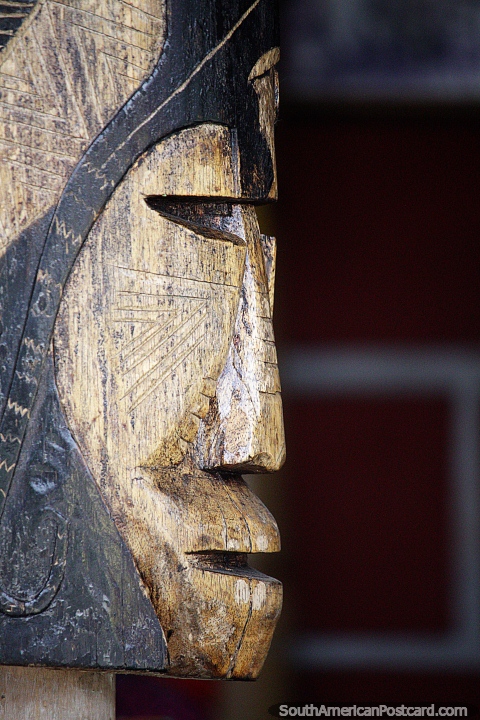 Carved wooden sculpture of an indigenous face in Pereira. (480x720px). Colombia, South America.