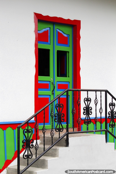 A welcoming front door, very colorful with stairs and railing leading up in Salento. (480x720px). Colombia, South America.