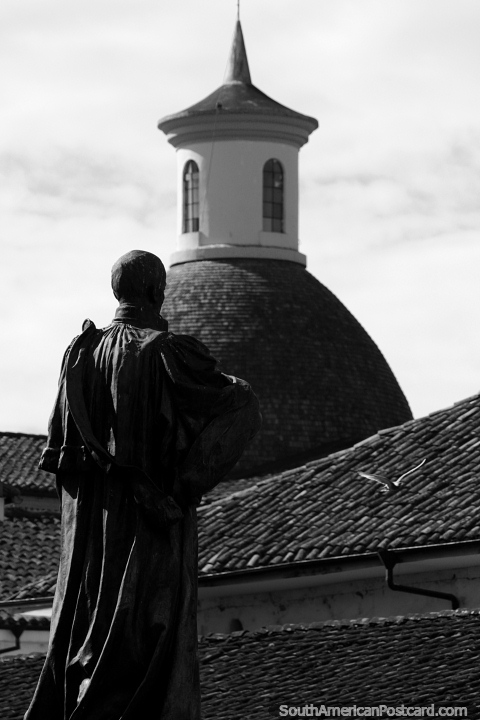 Priest looks across tiled roofs to a distant dome in Popayan. (480x720px). Colombia, South America.