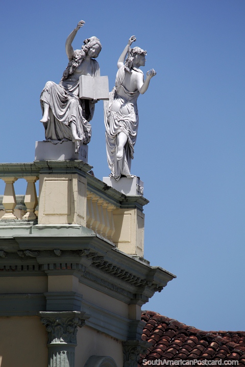 Pair of female figures celebrate at the top of the Municipal Theater in Popayan. (480x720px). Colombia, South America.