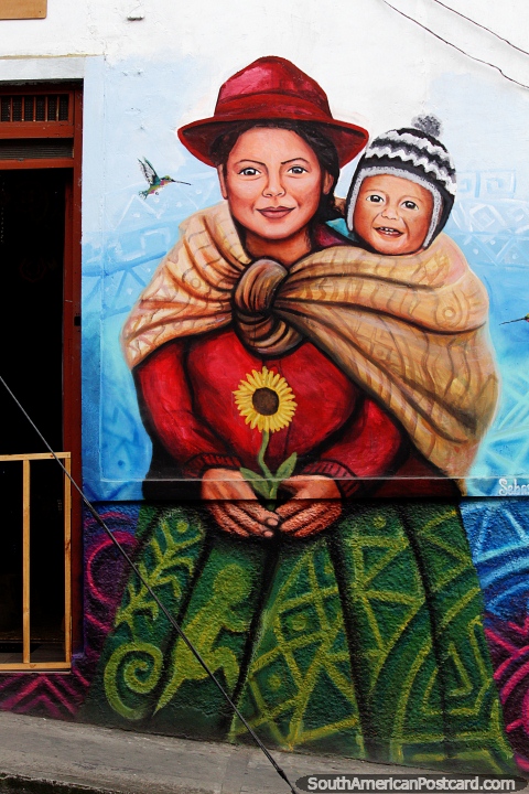 Indigenous woman and her child in a blanket on her back, fantastic mural in Pasto. (480x720px). Colombia, South America.