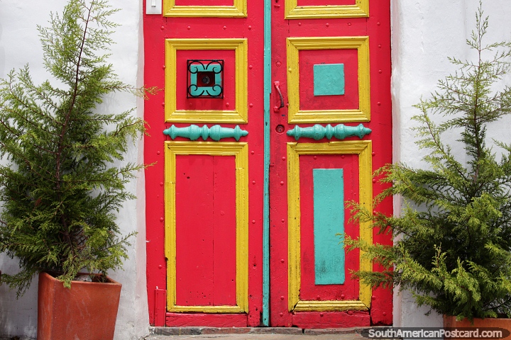 Red and yellow door with a small tree on each side, welcome home, La Candelaria, Bogota. (720x480px). Colombia, South America.