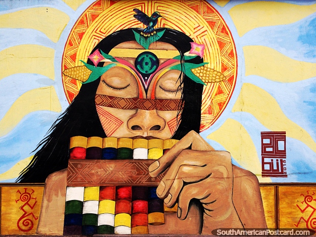 Homem indígena soprando tubos de madeira coloridos, mural de rua em Sogamoso. (640x480px). Colômbia, América do Sul.