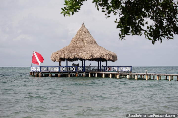 Jetty with seating area under a thatched roof, the open sea all around, Tintipan Island. (720x480px). Colombia, South America.
