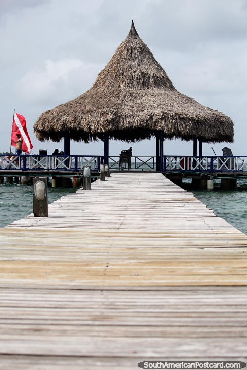 Wooden boardwalk of the jetty to the waiting station for boats at Tintipan Island. (480x720px). Colombia, South America.