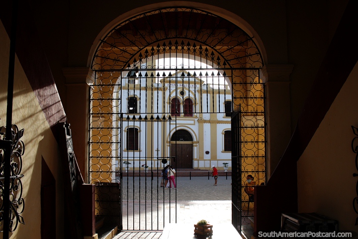 View through the archway of the old market towards the church of Lady Maria in Mompos. (720x480px). Colombia, South America.