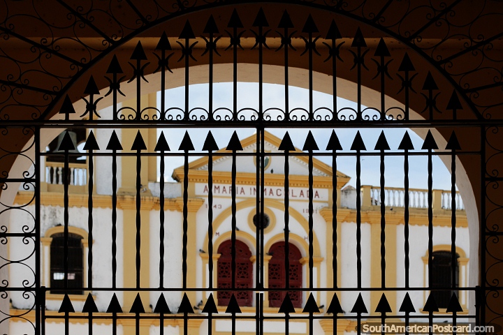 Gated archway looking towards a church facade in Mompos, photography fun. (720x480px). Colombia, South America.