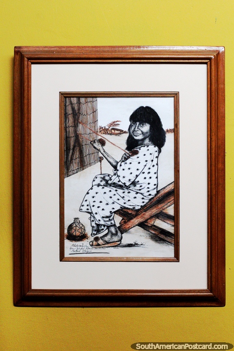 An indigenous woman weaving, drawing on display at Villa Real Archaeological Museum in San Agustin. (480x720px). Colombia, South America.