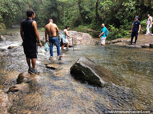 Crossing a river during the hike to the End of the World Waterfall in Mocoa. (640x480px). Colombia, South America.