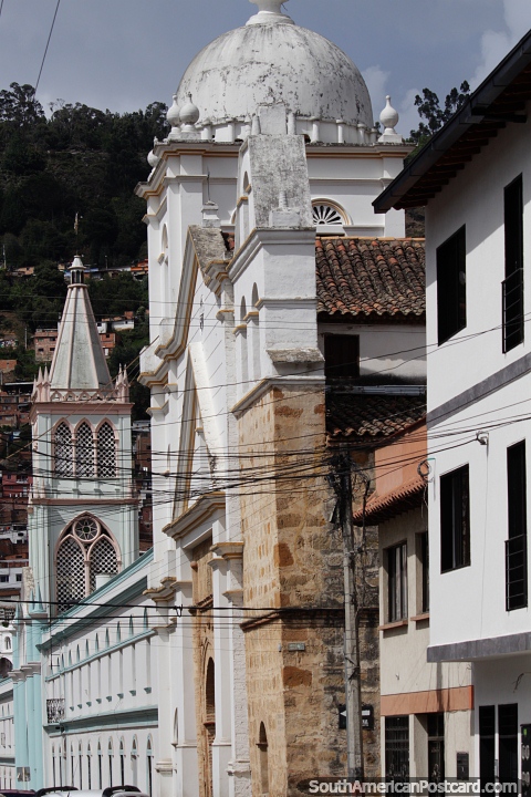 Long street view of historic buildings and churches in Pamplona. (480x720px). Colombia, South America.