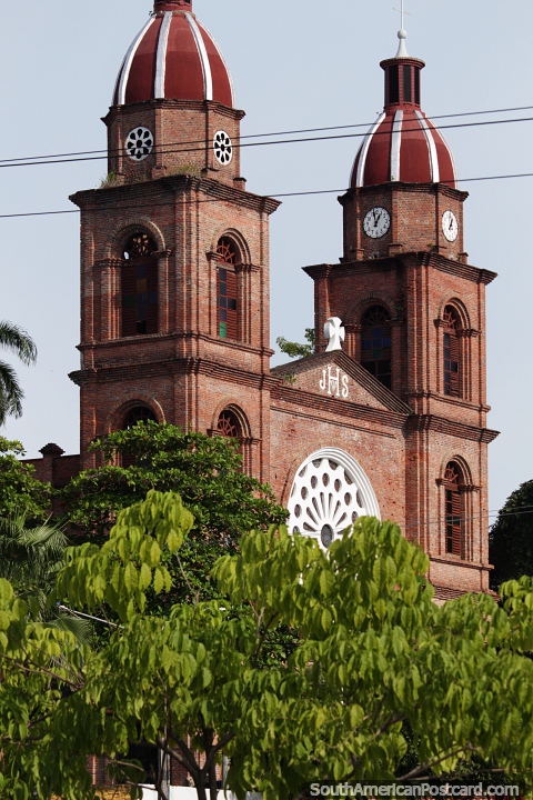 View of the cathedral in Barrancabermeja from down by the river, 2 tall towers. (480x720px). Colombia, South America.
